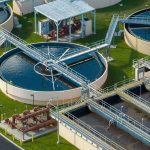 Silent Dumping Haunts The AI Rush Wastewater treatment plant with circular clarifiers and aeration tanks