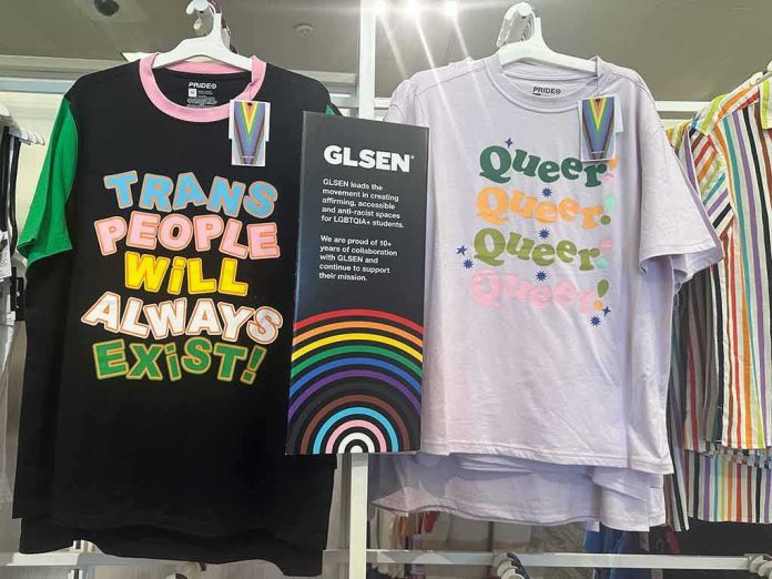 shutterstock_2307175777-2 Pride-themed T-shirts on store display with colorful slogans and rainbow sign