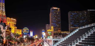 Las Vegas Strip at night with traffic and grandstand seating