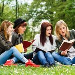 Spy Agency Accused Of Shutting Students Out Group of young women reading books on grass in a park
