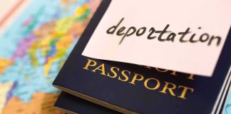 Stack of passports with a note labeled deportation on top, placed on a map