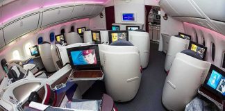Business class cabin with lie-flat seats and personal screens