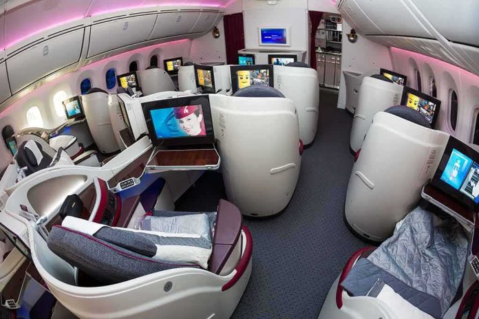Business class cabin with lie-flat seats and personal screens