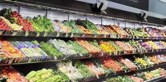 Tainted Lettuce Panic Sweeps 27 States Grocery store produce aisle with stacked fresh vegetables