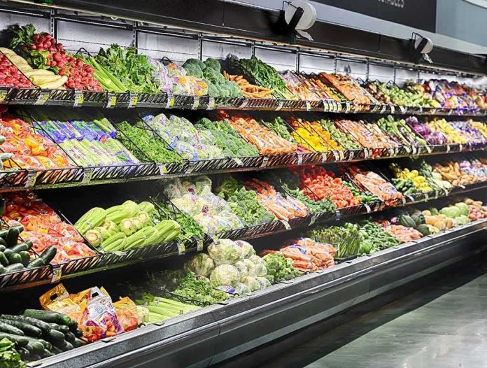 shutterstock_503073676 Grocery store produce aisle with stacked fresh vegetables