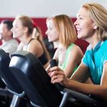 Backlash Erupts: Sport Turned Into Props group of people cycling on exercise bikes at a gym