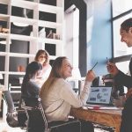 Coworkers collaborating at a desk in a modern office