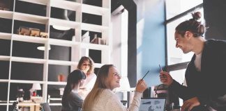 162,000 New Jobs Keep The Economy Moving Coworkers collaborating at a desk in a modern office