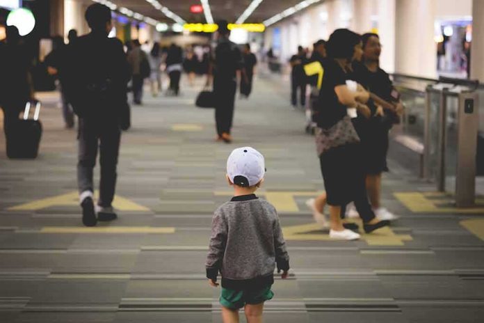 shutterstock_664720846 child walking through a busy airport corridor