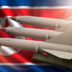 Beijing’s Silence Turbocharges Kim’s Nukes Missiles in front of North Korea flag