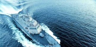 Naval warship cutting through open sea