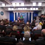 Family Matter? Voters Smell a Cover-Up Press secretary at podium addressing reporters in briefing room