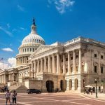 Deep State Shield Or Democracy Killer? United States Capitol building with dome and columns under a blue sky