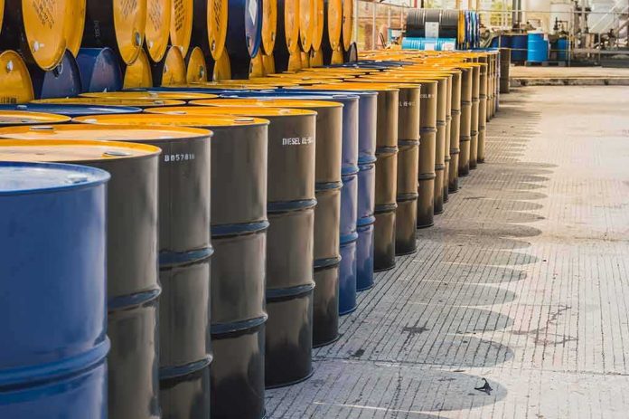 shutterstock_1082741726-2 Rows of industrial metal barrels with yellow lids