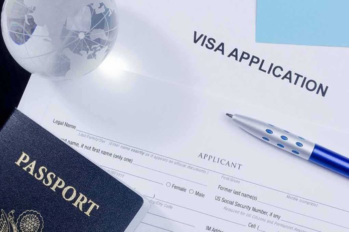 Visa application form with passport and pen