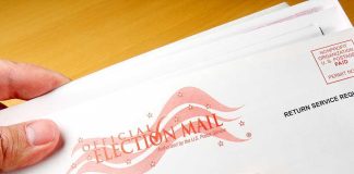 Capitol Mail Scare Triggers Evacuations A hand holding an envelope labeled Official Election Mail