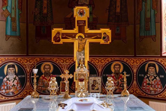 Orthodox church altar with large gilded cross and icons