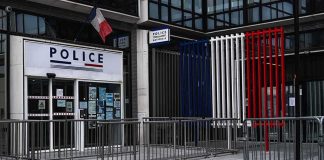 US Marine Faces Murder Charges After Hotel Killing Police station entrance with barriers and French flag colors