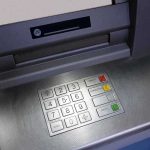 Close-up of an ATM keypad with numeric buttons and function keys