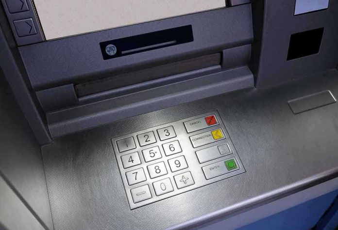 Close-up of an ATM keypad with numeric buttons and function keys