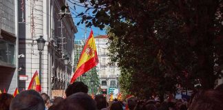 Housing Crisis Sends Thousands Into The Streets Crowd with Spanish flags in a city street
