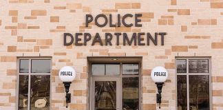 Shocking Probe Rattles St. Paul City Hall Police department building entrance with signage