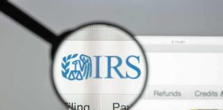 Magnifying glass highlighting IRS logo on a website