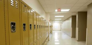 Row of yellow school lockers in an empty hallway