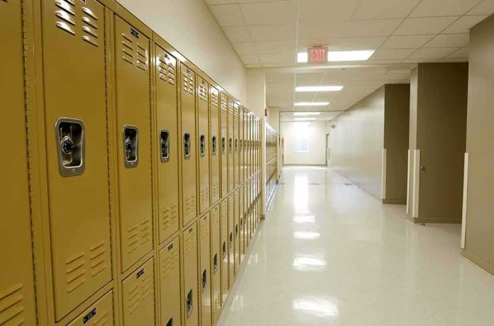 Row of yellow school lockers in an empty hallway